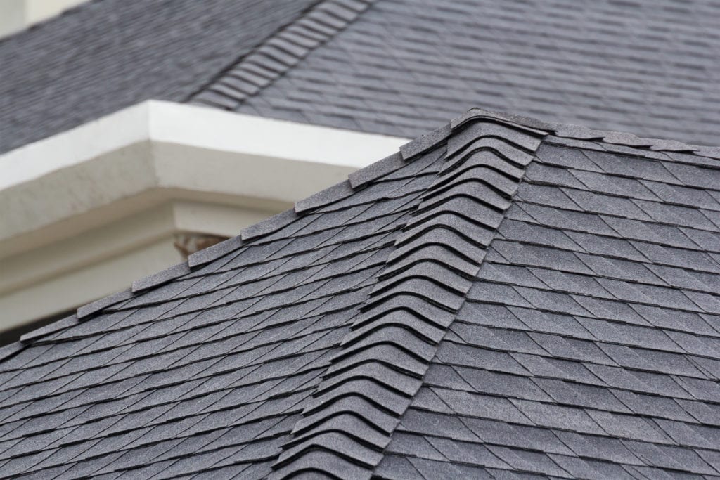 Close-up of a textured asphalt shingle roof, illustrating roofing material options for homeowners considering durability and aesthetics.